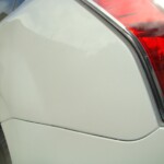 Before and after photographs of a damaged white Subaru that was repaired by Elite Paint & Body Shop in West Palm Beach, Florida